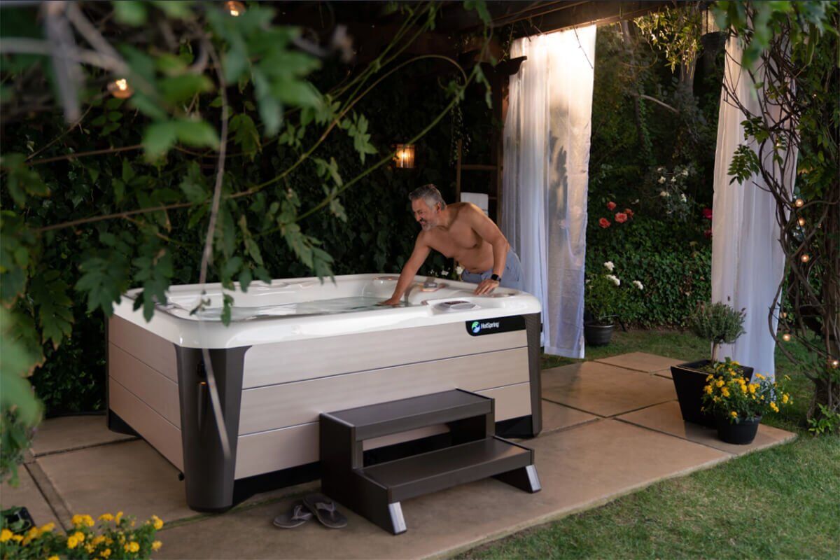 A tranquil backyard retreat featuring a Hot Spring spa, ideal for unwinding and stress relief.